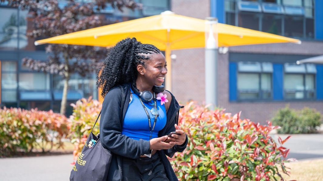 A Student walking on the campus grounds.