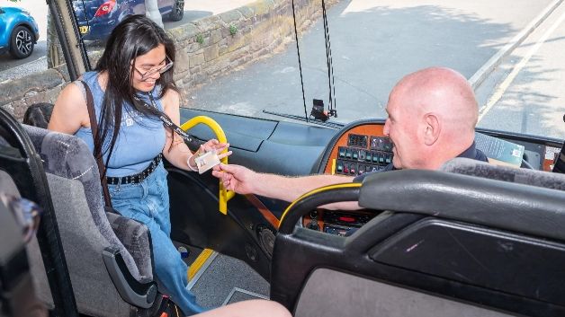 A student getting on a bus.