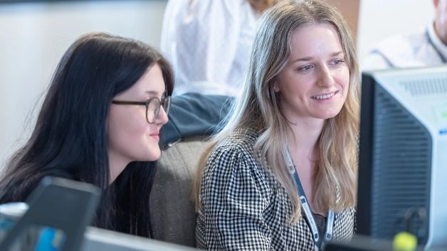 A Teacher and her student looking on the computer.