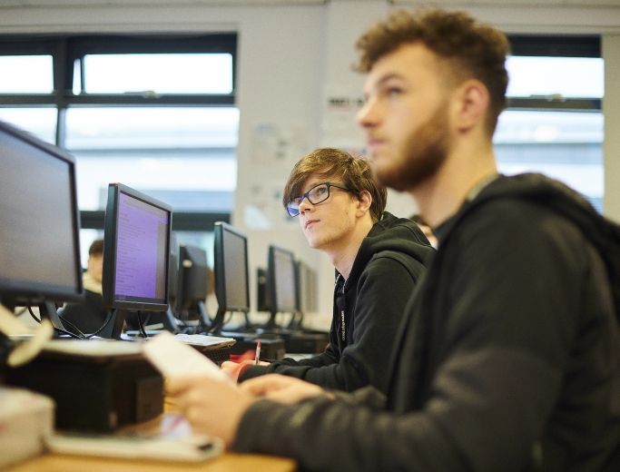 Computer Science students sat at their computers.