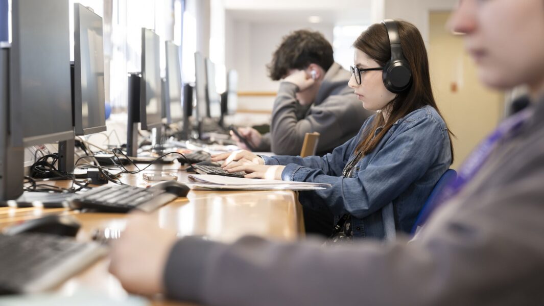 students using the computers in the livbrary at Carmel