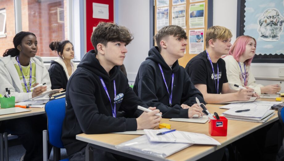 Male students sat at desks in a classroom