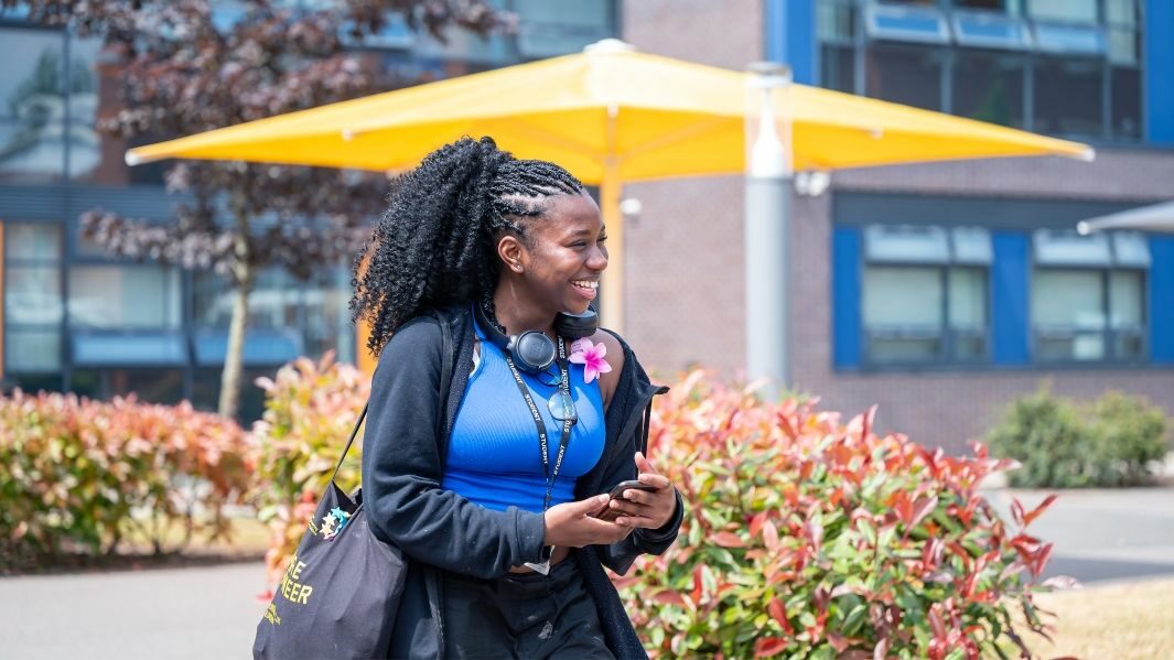 A Student walking on the Carmel College Campus.