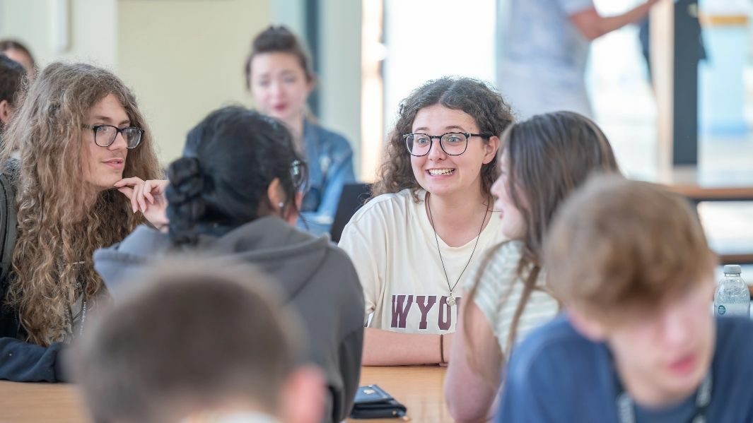 A group of students talking in the canteen.
