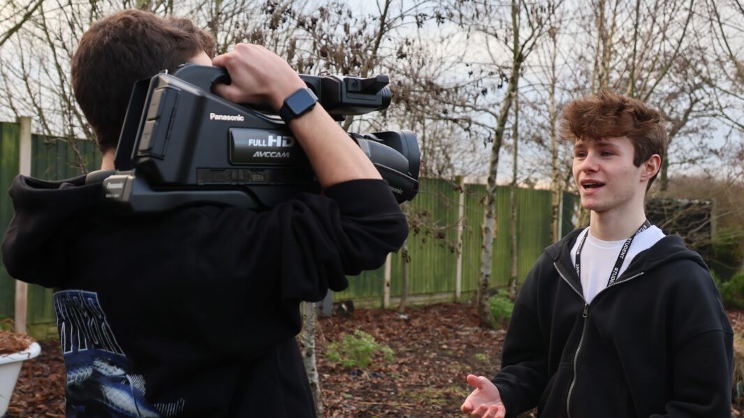 Photo of male and female students using film equipment