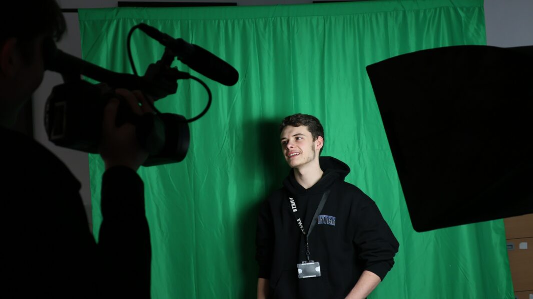 Photo of male student using film equipment