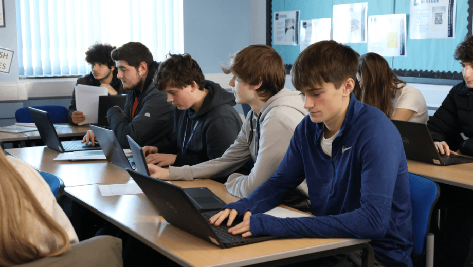 Students sat at desk working on laptops. level 3 courses