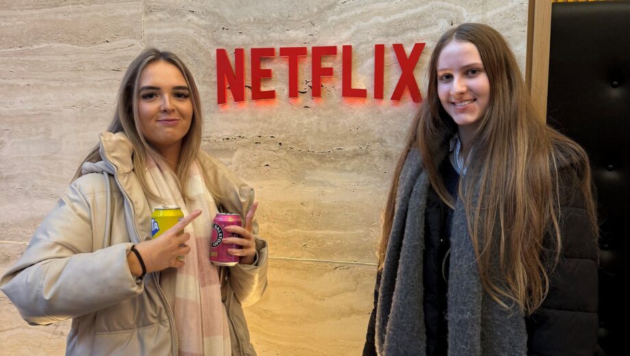 2 female students stood in front of the Netflix sign