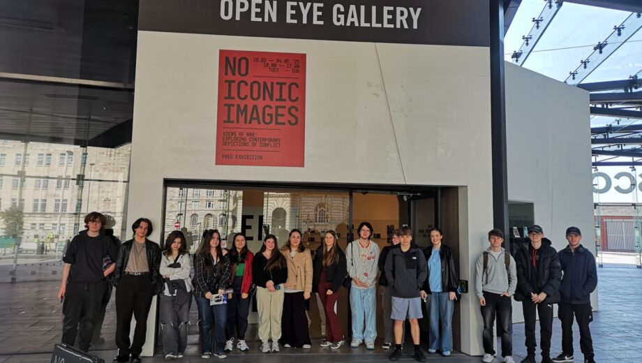 A large group of students outside the Open Eye Gallery