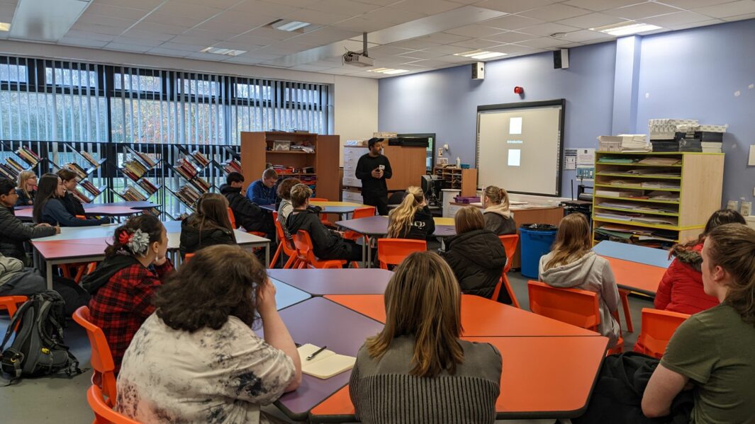 students sat in an art classroom workshop