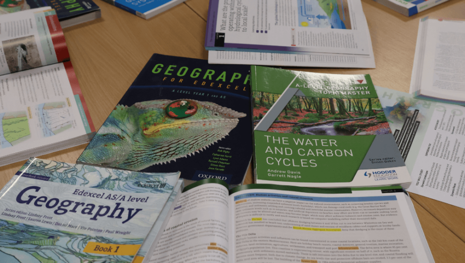 a table full of geography course books