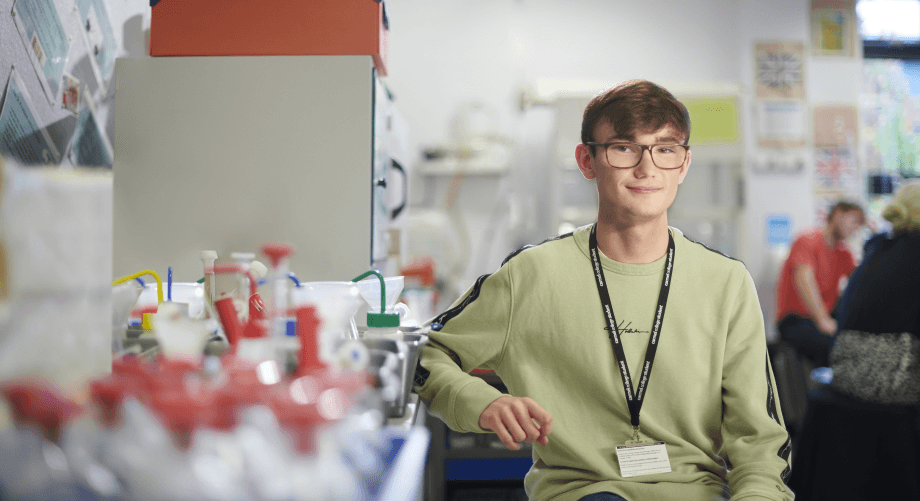 Portrait image of student sat in Chemistry classroom carmel college