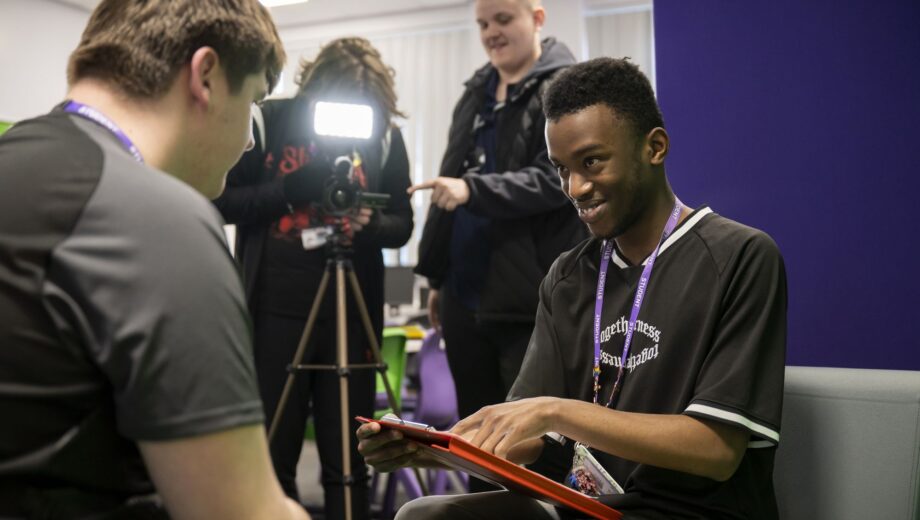 Male student sat down interviewing another student