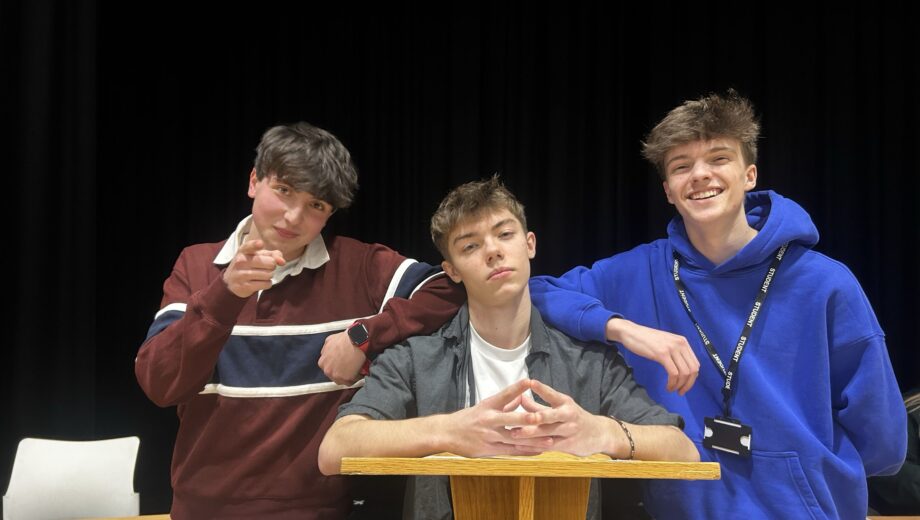 Group of 3 students at a lectern