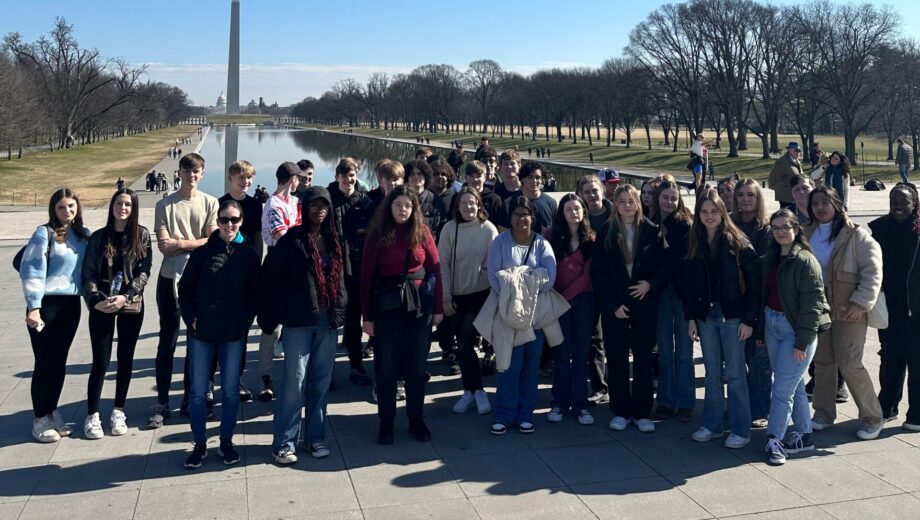 Large group of students stood in Washington in front of a land mark