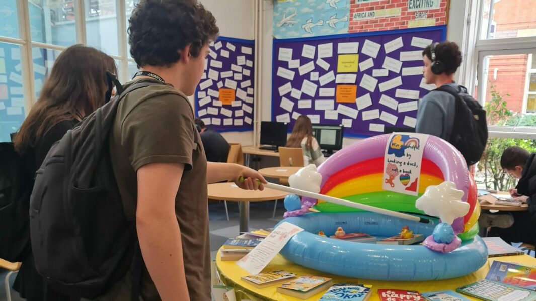 Students in the library playing hook a duck