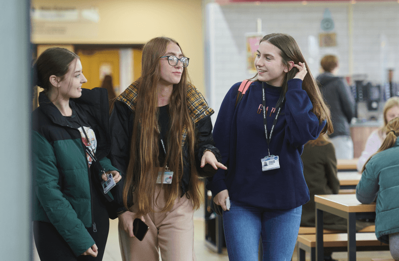 Female students walking through the cafe at Carmel College in St Helens