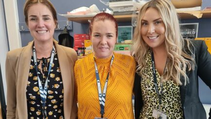 3 female tutors wearing yellow for mental health day