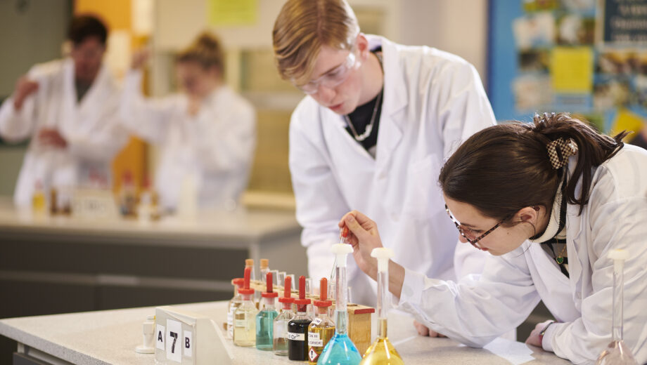 Male and female student in a science lab