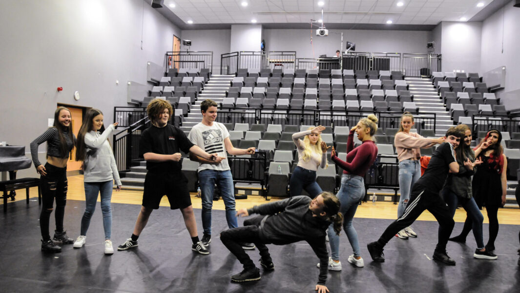 Male and female students performing in the Dalton theatre at Cramel College