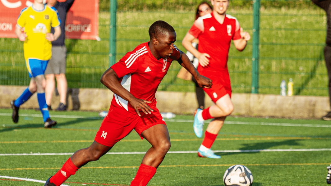 Male student playing football at Carmel College sixth form college