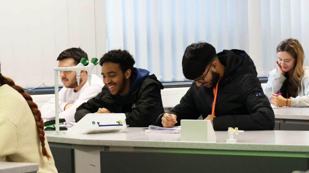 male students working in a science lab at Carmel College
