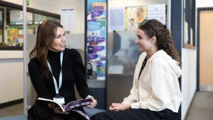 Female tutor and female student sat in the careers area at Carmel College