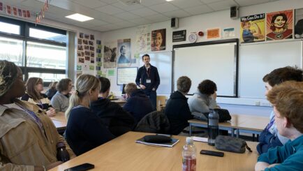 Ryan Wain delivering talk to a group of students in a classroom