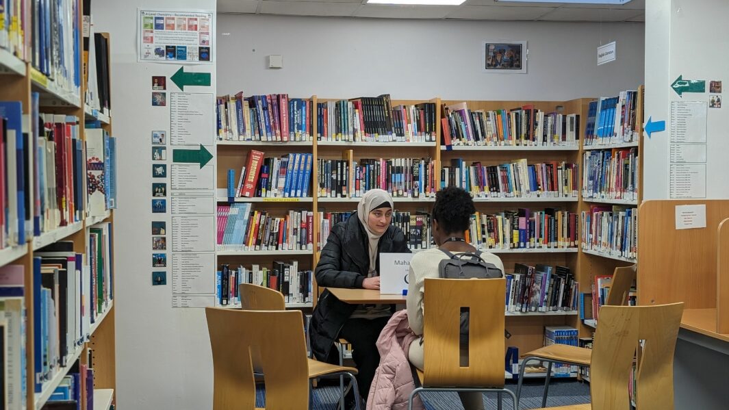 students sat at table in library