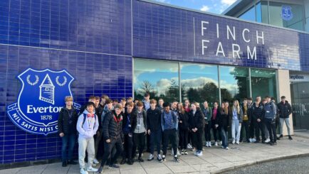 Group of PE students outside Everton's Finch Farm ground. college near me