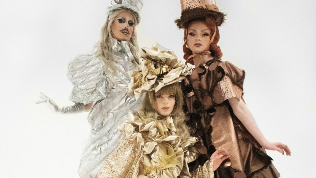 three models posing in high fashion outifts