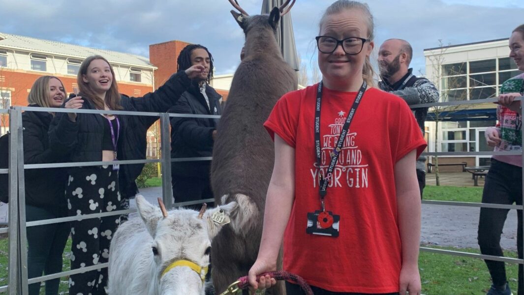 female student and reindeer at carmel college outside