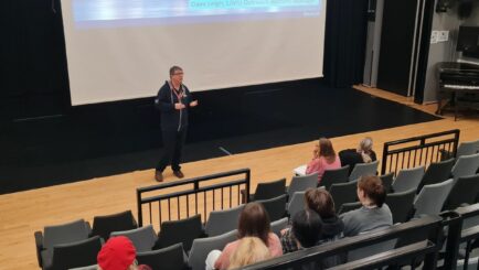 Rep from LJMU talking at front of Dalton Theatre to an audience