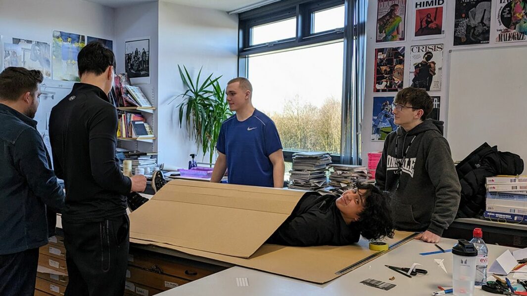 Art and Design students taking part in a design workshop ran by Place Education building a homeless shelter from materials in a classroom