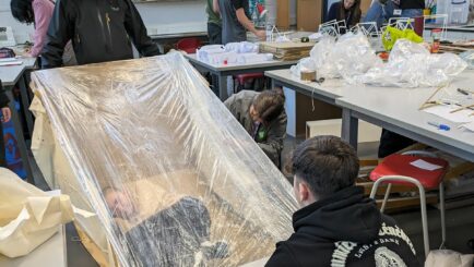 Art and Design students taking part in a design workshop ran by Place Education building a homeless shelter from materials in a classroom
