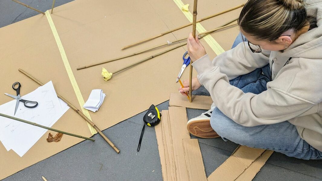 Art and Design students taking part in a design workshop ran by Place Education building a homeless shelter from materials in a classroom