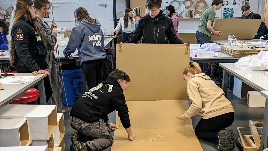 Art and Design students taking part in a design workshop ran by Place Education building a homeless shelter from materials in a classroom