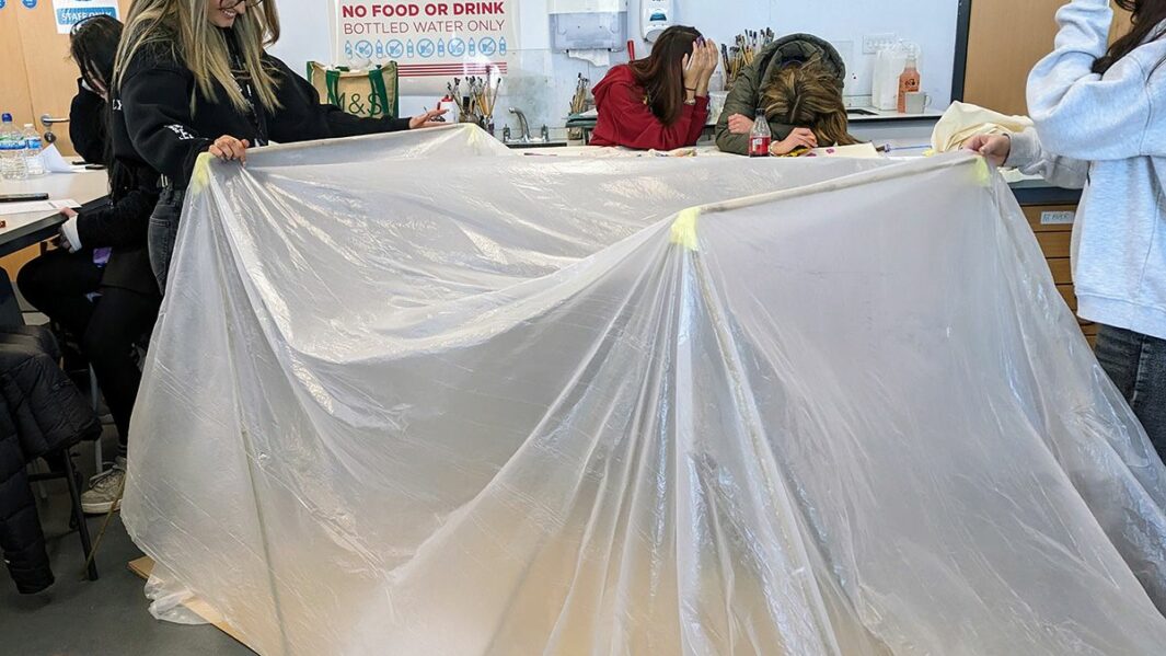 Art and Design students taking part in a design workshop ran by Place Education building a homeless shelter from materials in a classroom