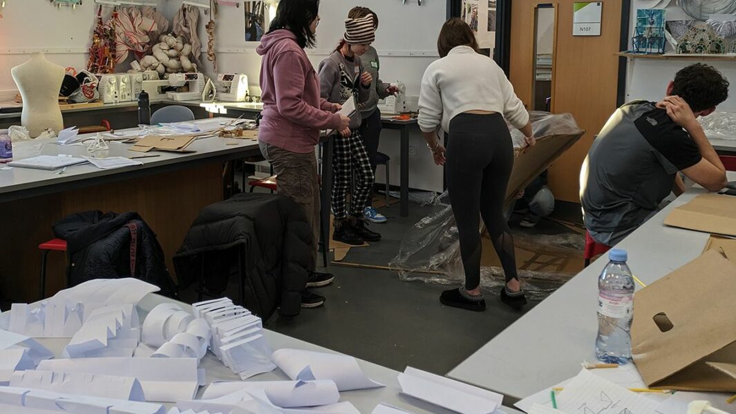 Art and Design students taking part in a design workshop ran by Place Education building a homeless shelter from materials in a classroom