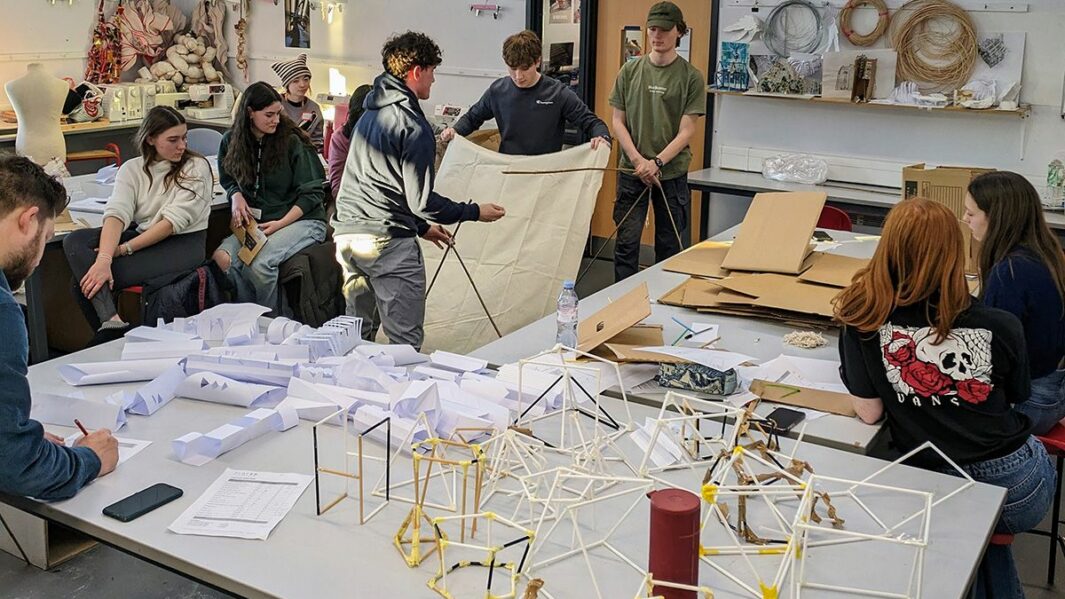 Art and Design students taking part in a design workshop ran by Place Education building a homeless shelter from materials in a classroom