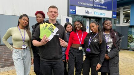 A group of female students stood outside college with Loud Speaker workshop provider Matt Powell