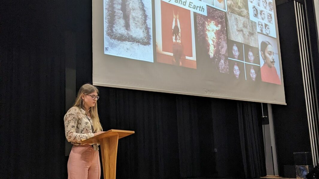 Female student presenting in the theatre