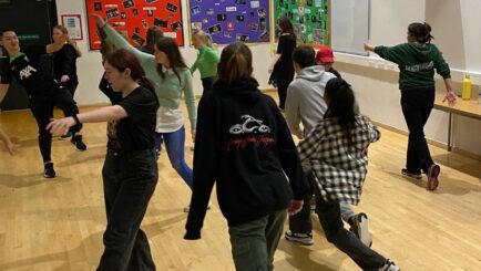 Students taking part in a theatre workshop in the dance studio