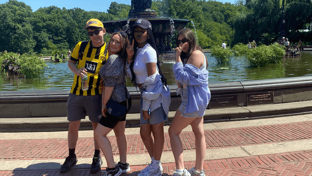 Group of Carmel College A level students pose in front of iconic fountain at Central Park during their New York City
