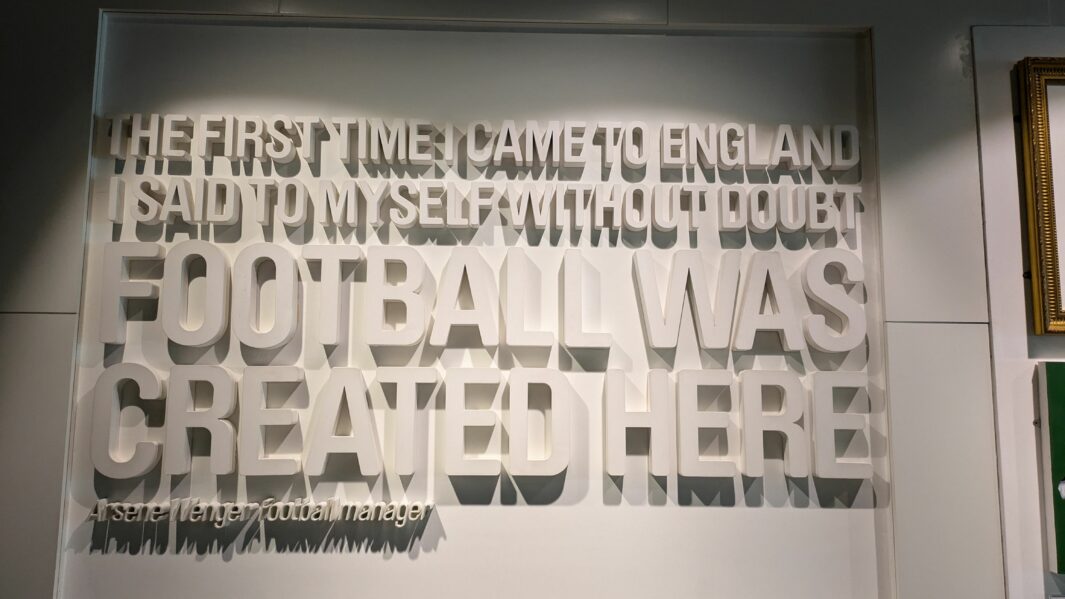A piece of artwork which includes white words on a wall that stand out