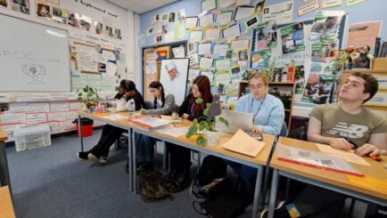 Students sat at desks at Derby uni in an English workshop