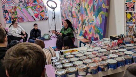 students attending a talk at an art studio