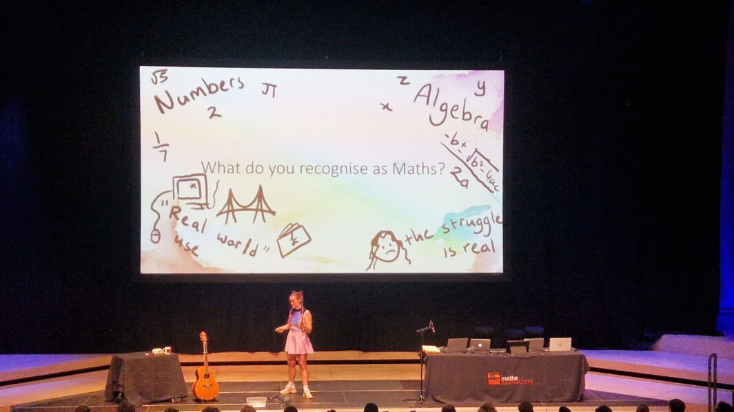 screen and a speaker delivering a talk to an audience at the Northern College of Music