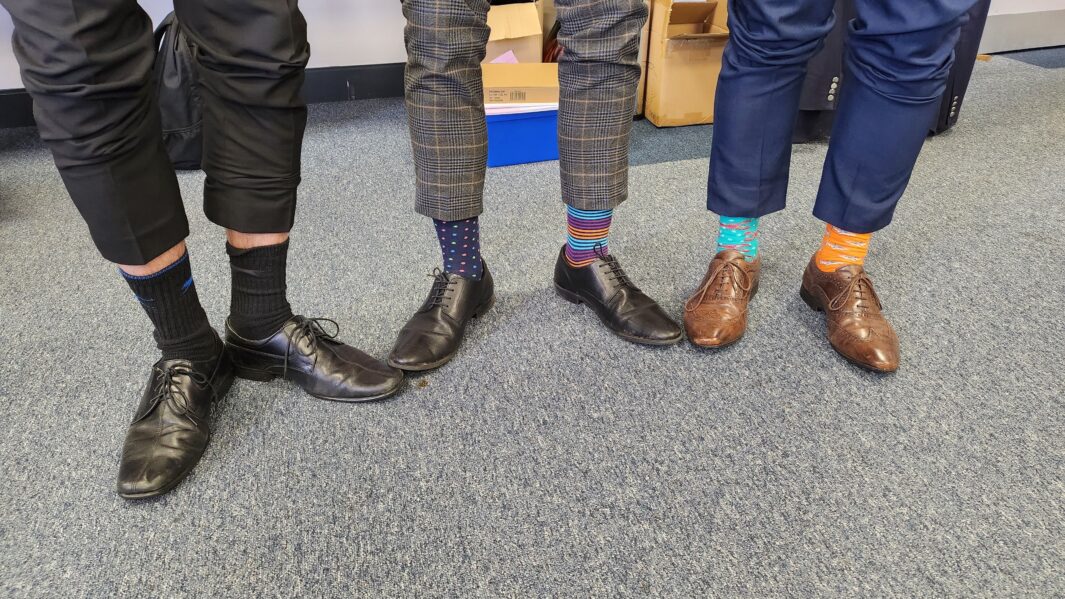 3 pairs of feet wearing odd socks