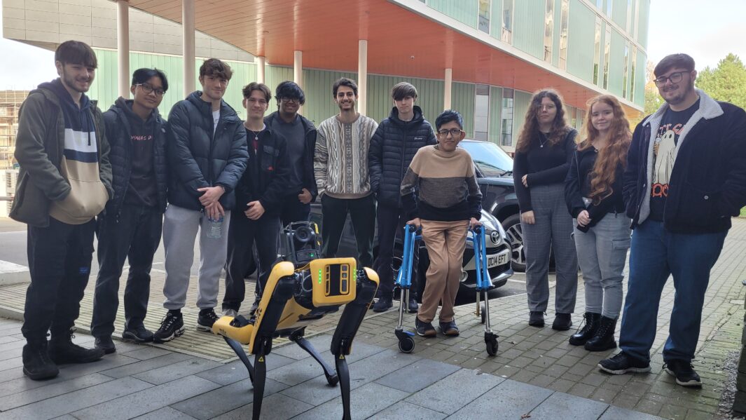 group of students at a the centre with a robot